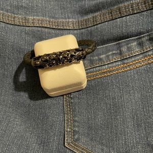 Faux-leather black bracelet, with metal and rhinestone detail. Magnetic closure